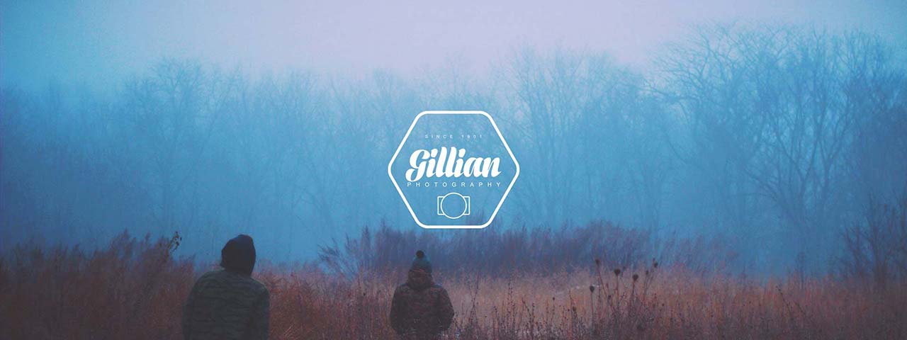 Two people walking in a foggy field.